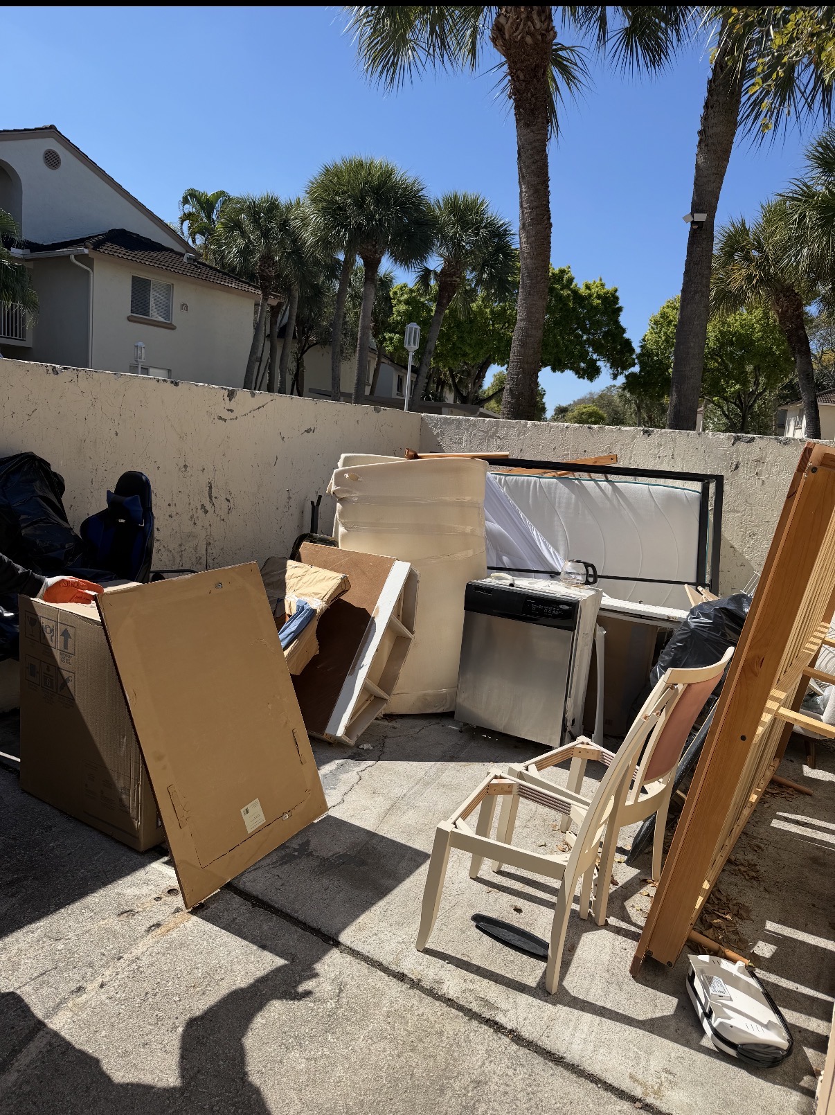 Apartment complex bulk waste pileup before Junk Force removal Palm Beach County FL